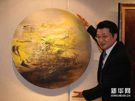 香港佳士得拍卖行工作人员在介绍即将拍卖的赵无极的油画作品。新华网图片 黄本强 摄