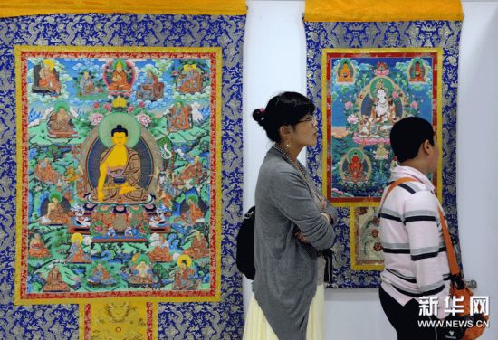 （3）10月1日，参观者在青海热贡唐卡艺术展上欣赏唐卡。